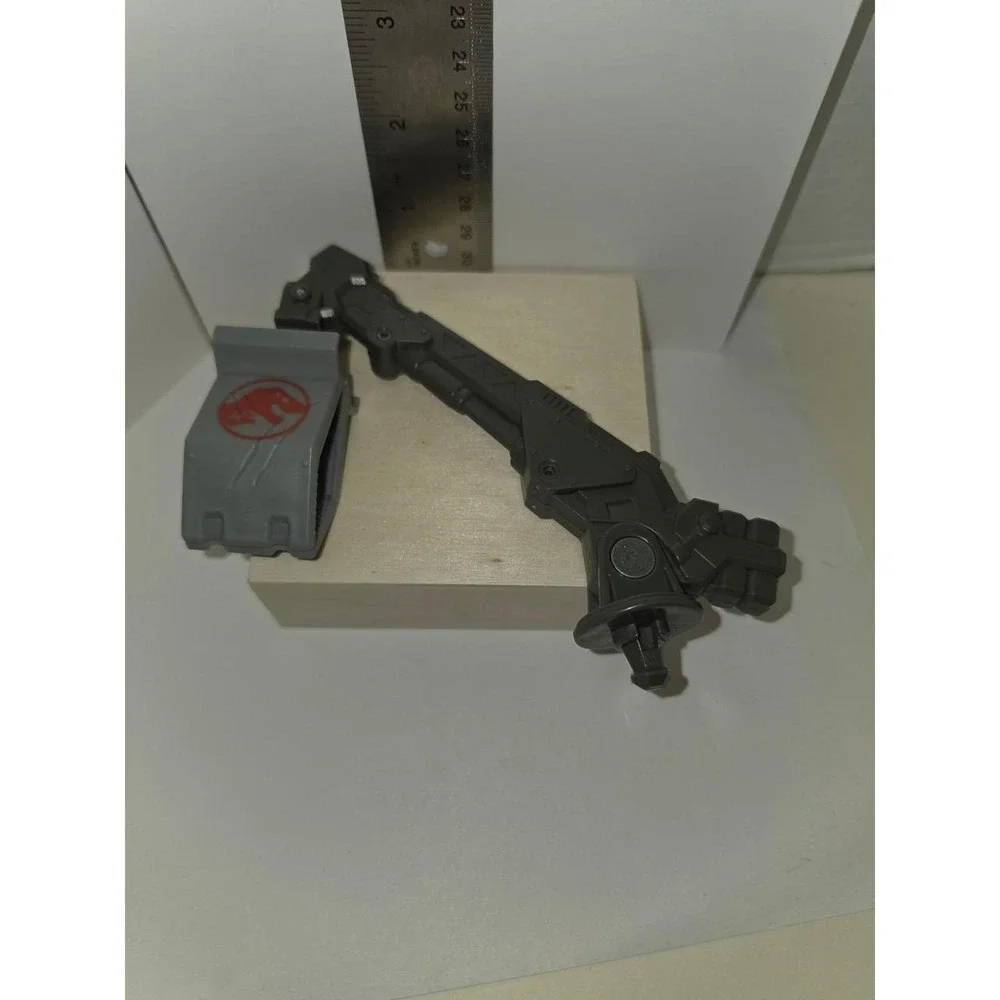 Jurassic World or similar action figure line, featuring a gray grapple-like arm